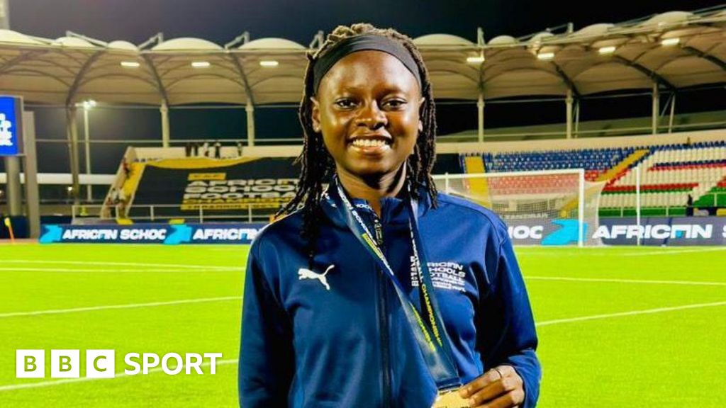 Nigerian football referee Gbemisola Yusuf poses with her medal in a stadium