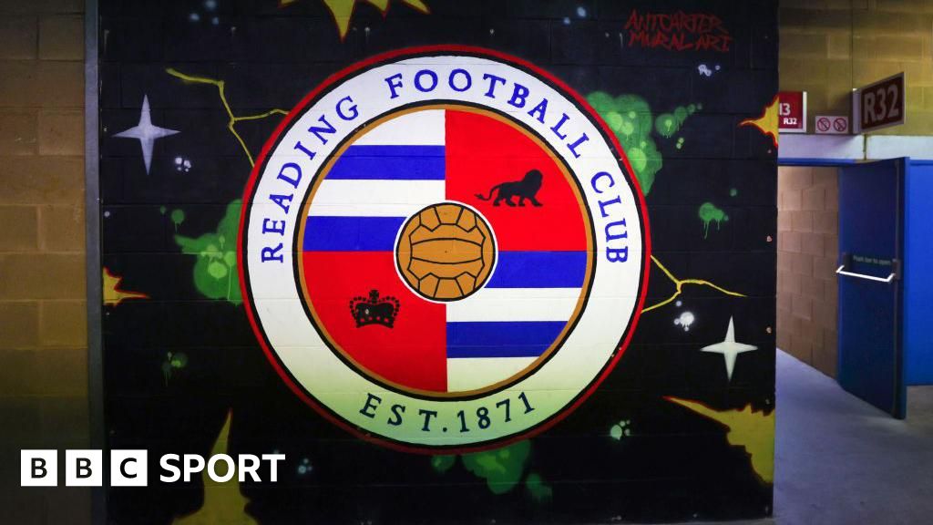 A mural of the Reading club badge on a wall inside the Select Car Leasing Stadium.