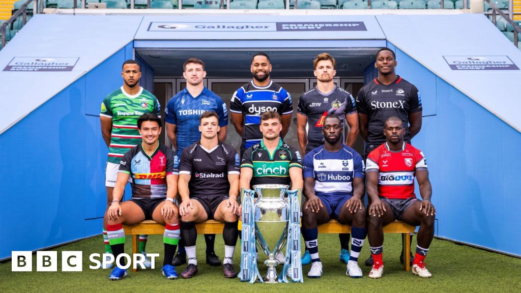 A player from each Premiership rugby club sitting and standing behind the Premiership trophy