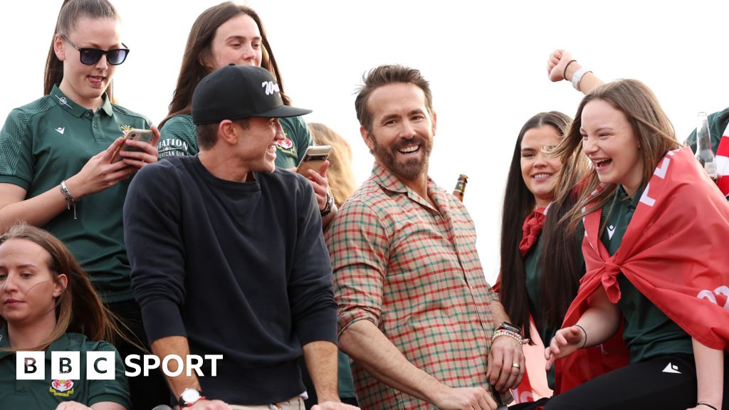 Rob McElhenney and Ryan Reynolds celebrate Wrexham's promotion in 2023