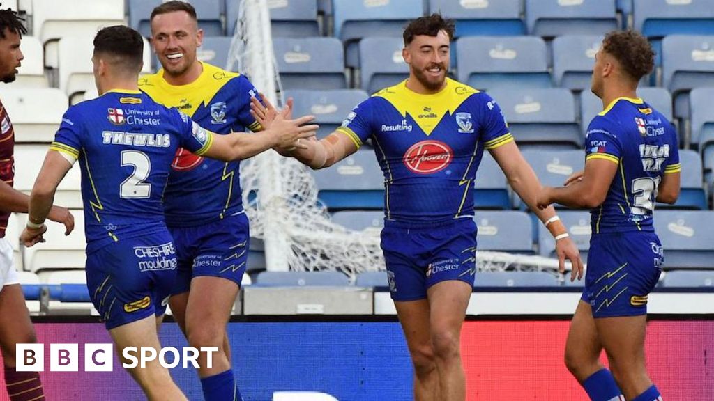 Matty Ashton celebrates his first try with his Warrington Wolves team-mates.