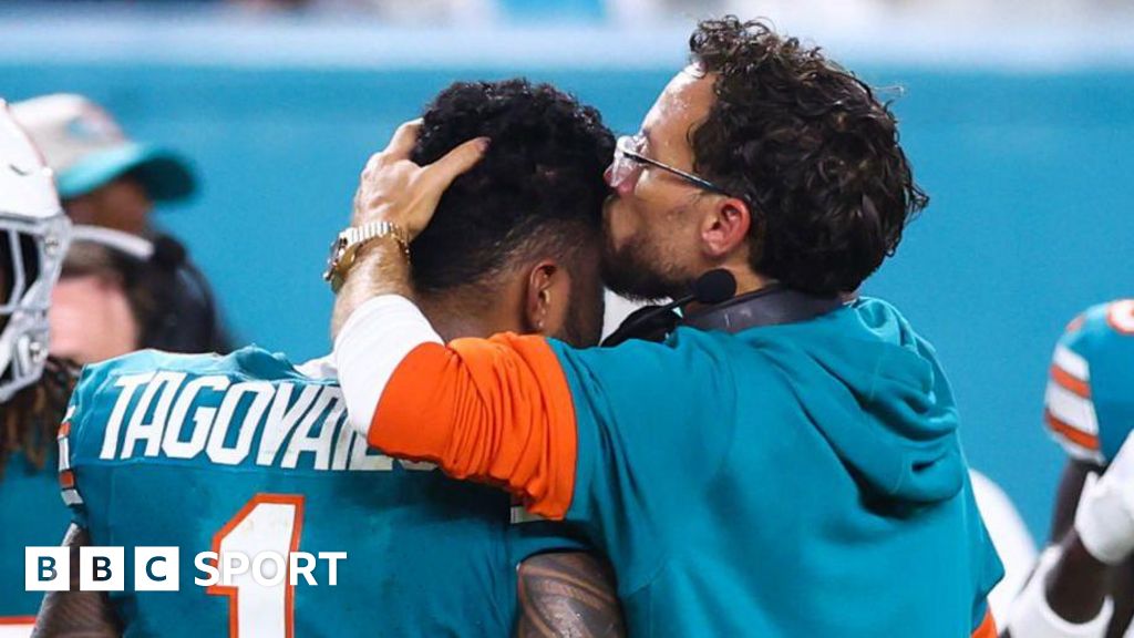 Miami Dolphins coach Mike McDaniel kisses quarterback Tua Tagovailoa on the head as he leaves the field after suffering a concussion in September 2024