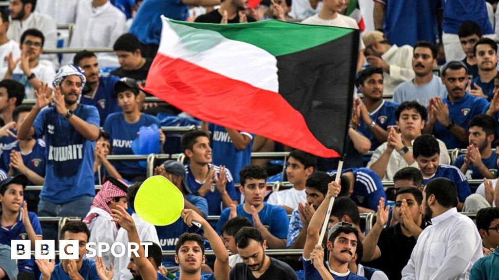 Fans fly a Kuwait flag inside the Jaber Al-Ahmad International Stadium during Tuesday's World Cup qualifier against Iraq