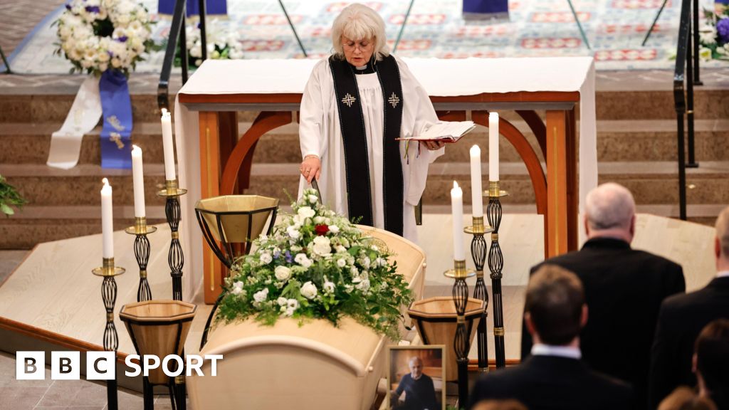 A priest stands next to the coffin of Sven-Goran Eriksson