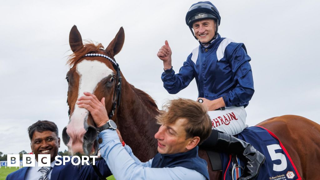 Tom Marquand celebrates after his Irish Champions Stakes on Economics at Leopardstown